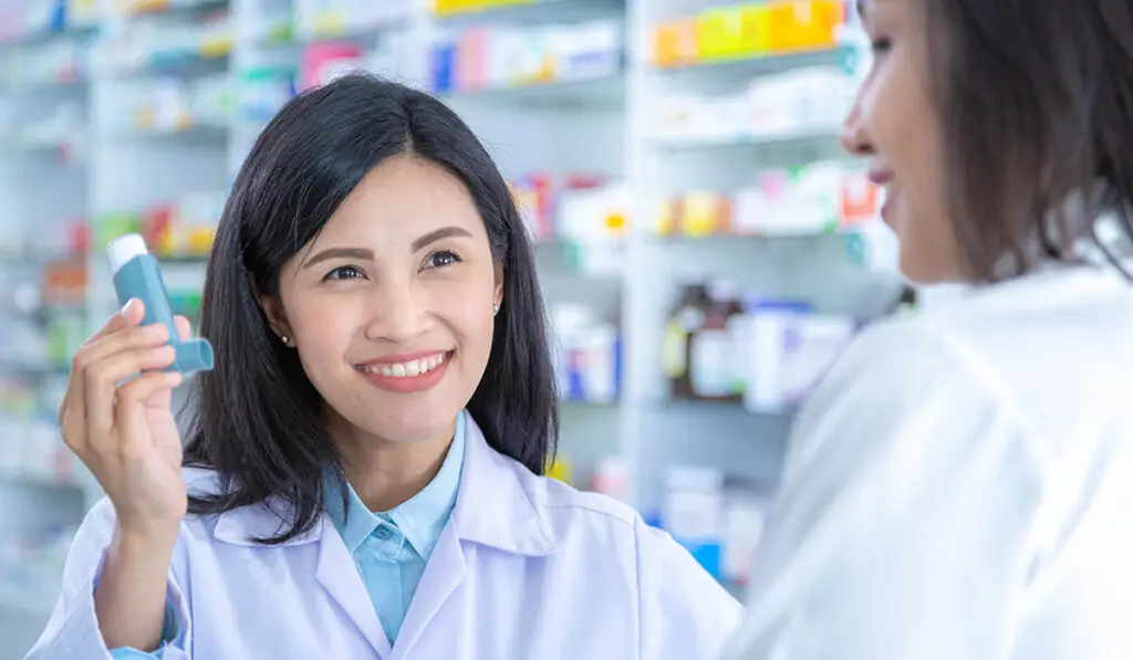 Woman talking to her pharmacist about inhaler