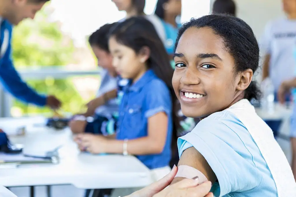 Young girl receives vaccine