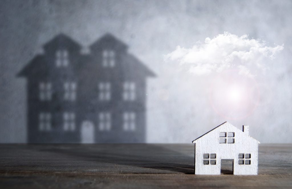 Smaller home in the shadow of a large home