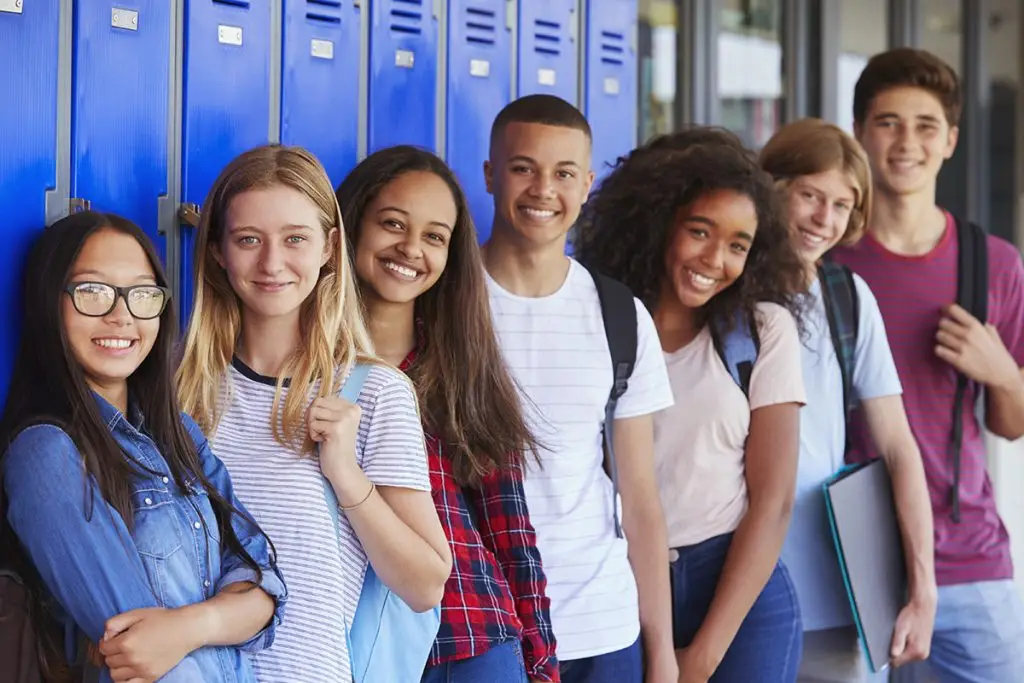 Young teens standing in school highway