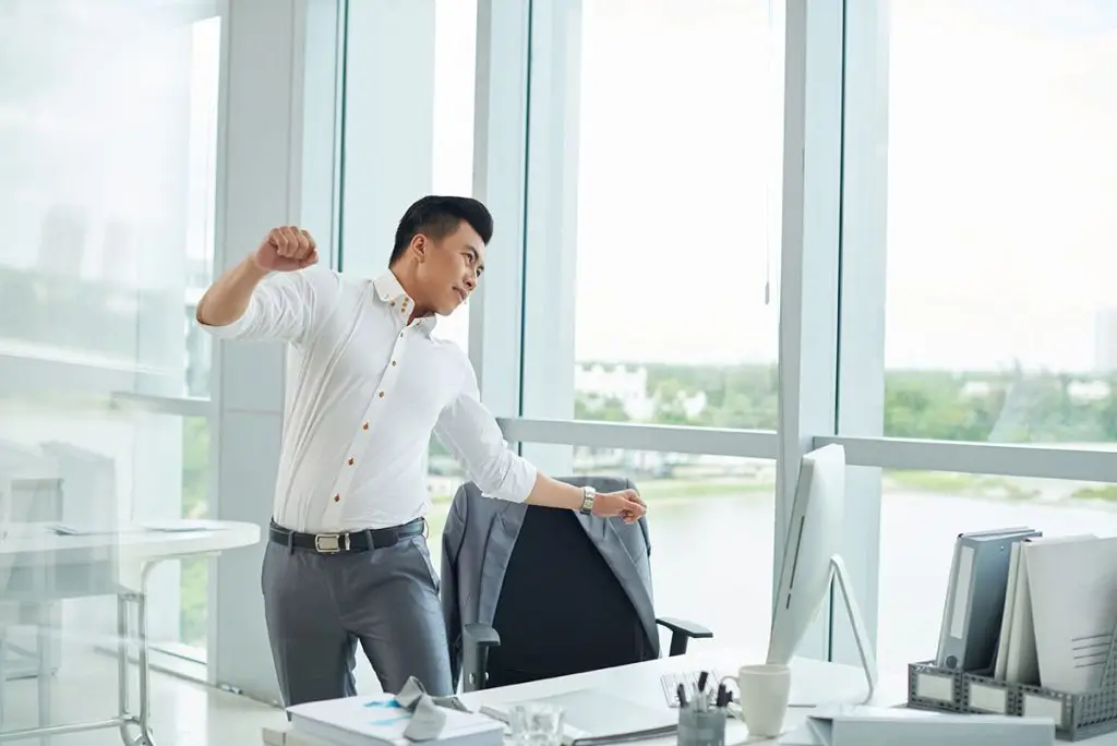Man stretching at his desk