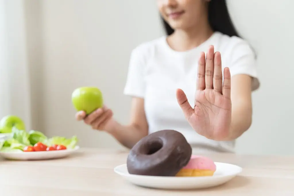 Woman refusing food with added sugars