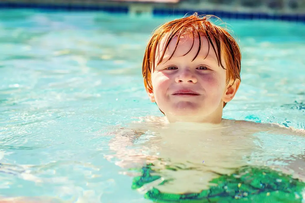 Young boy swimming in pool
