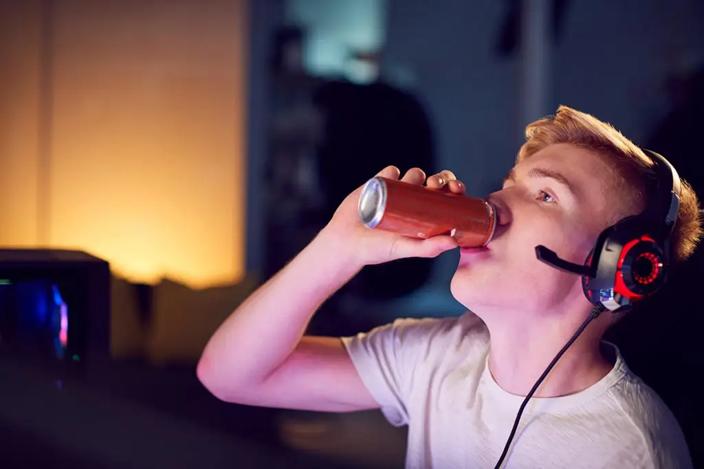Teenager drinking an energy drink
