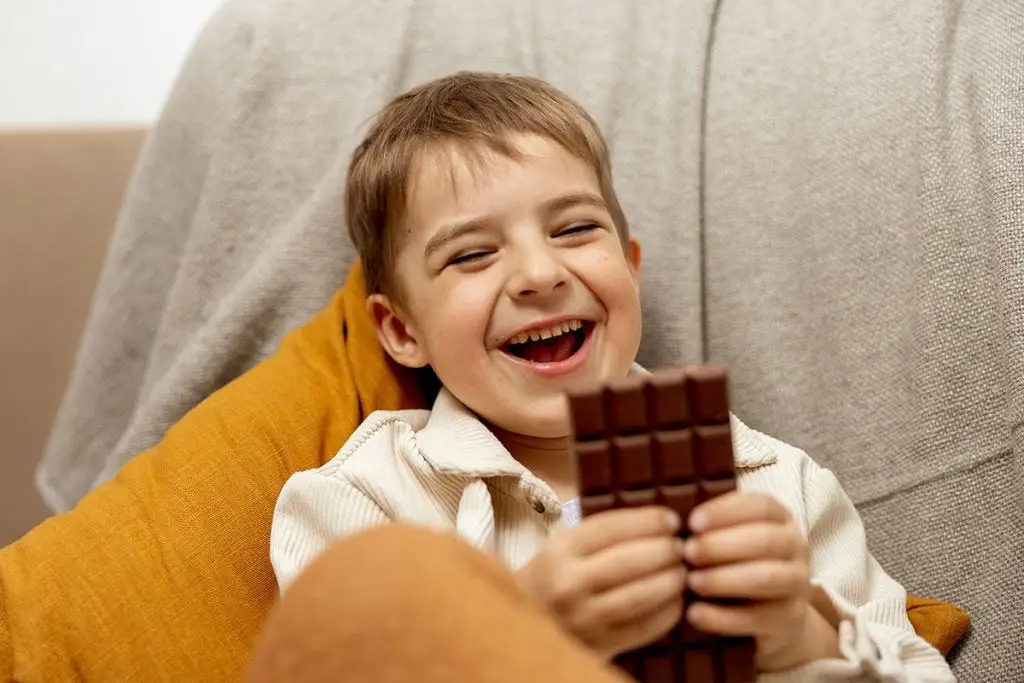 Little boy eating chocolate