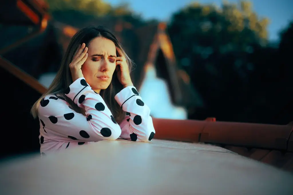 Woman with headache suffering from caffeine withdrawals