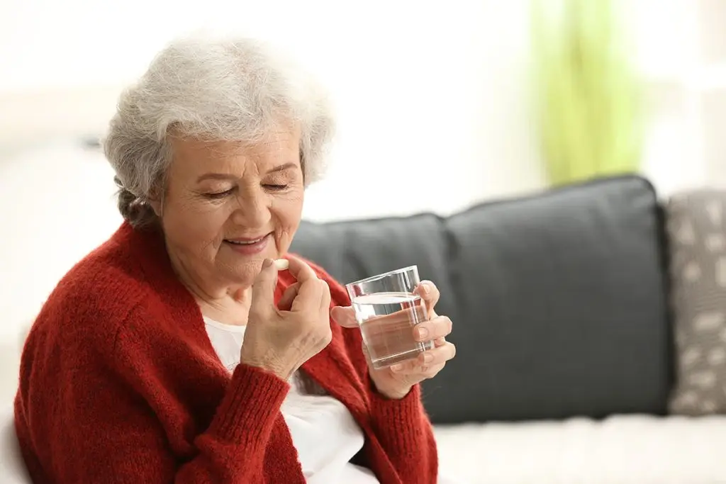woman taking calcium supplement for osteoporosis