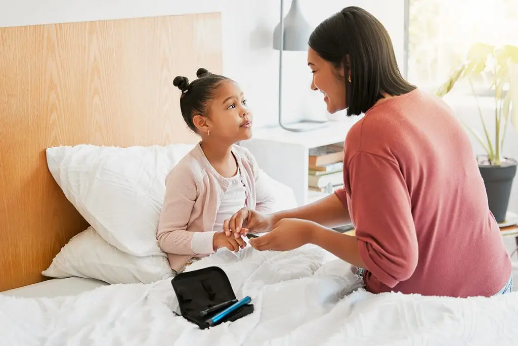 Child getting her blood sugar checked
