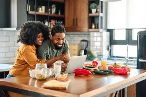Couple looking at computer in the kitchen