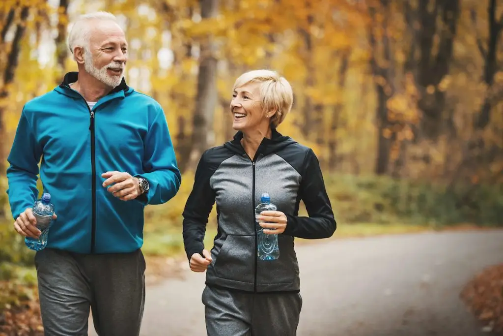 Older couple jogging outside
