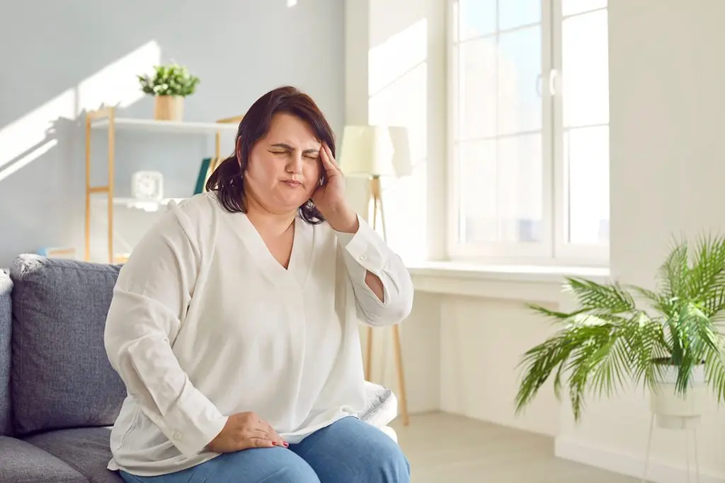 Woman holding her head in pain