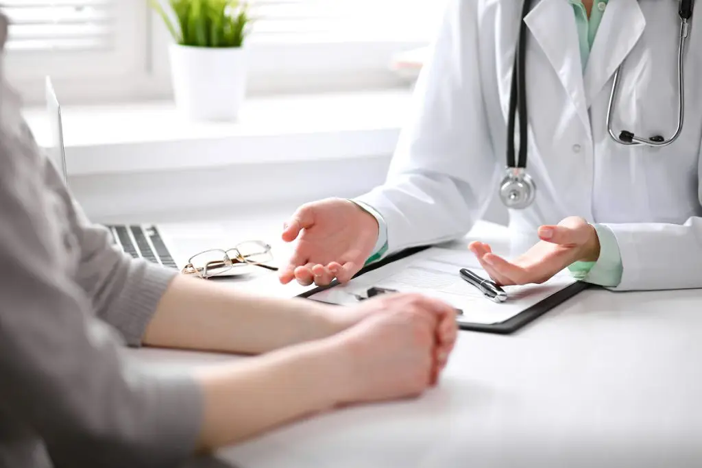 Doctor sitting across from patient at desk