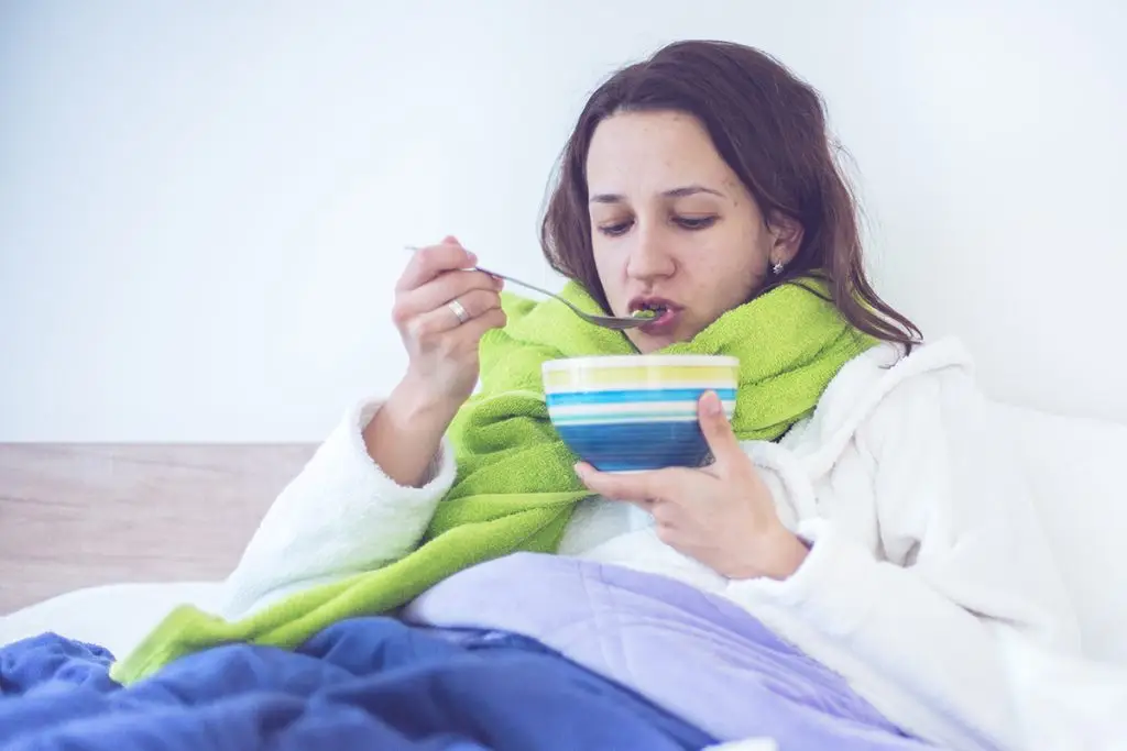 Eating soup while sick in bed