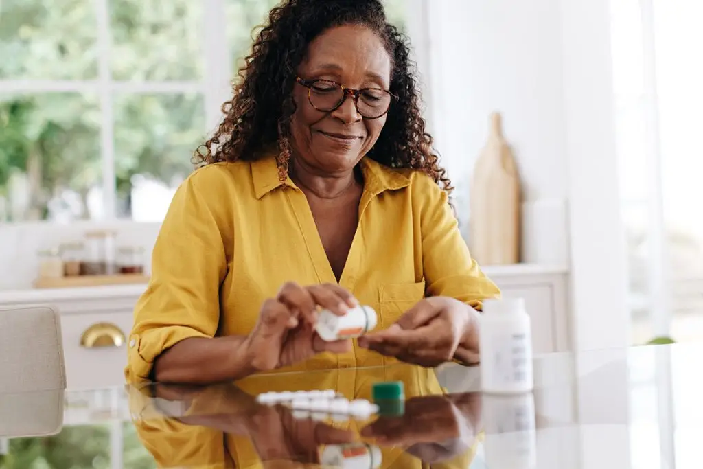 Happy woman taking medications