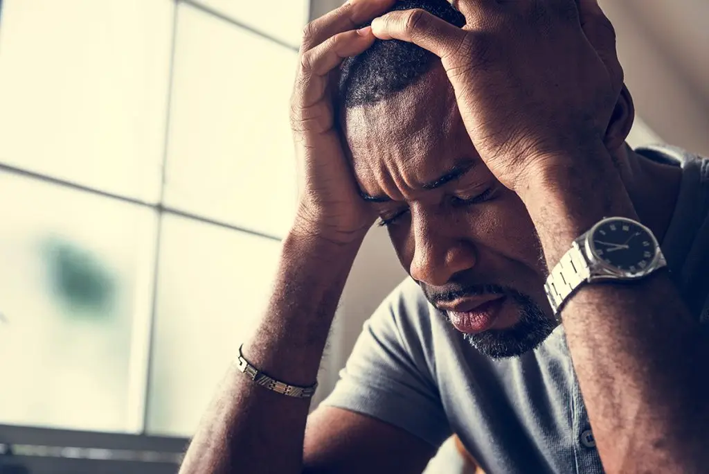 Man holding his head in pain