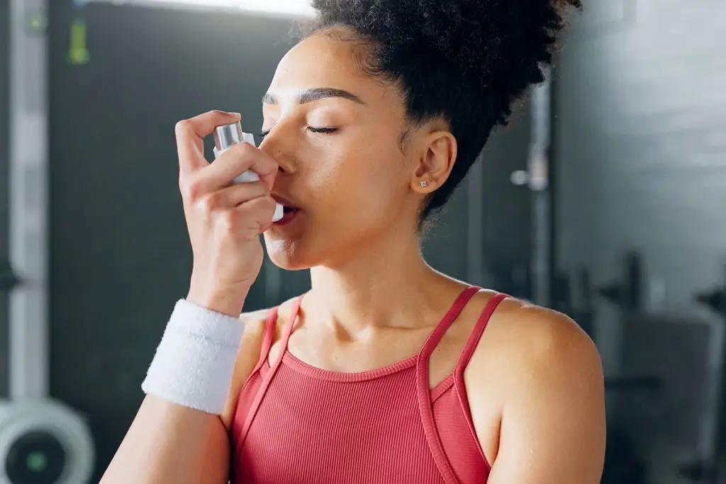 Woman using an inhaler