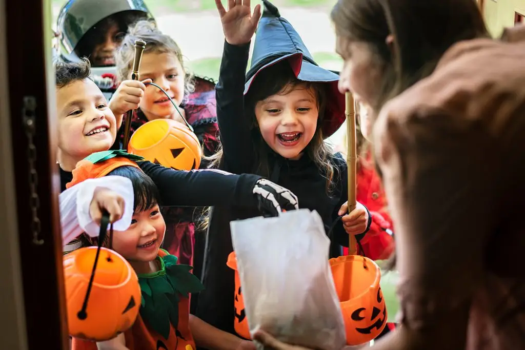 Group of children at a door on Halloween trick-or-treating