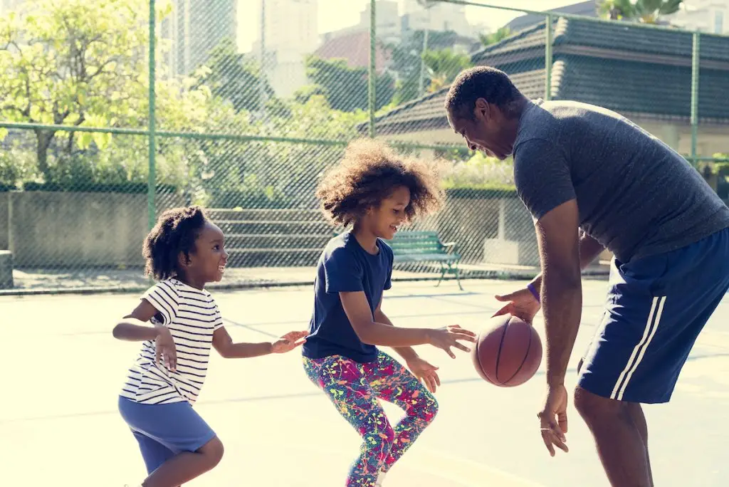 Man Playing Basketball With Children
