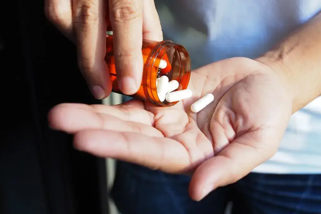 Woman pouring medication into her hand