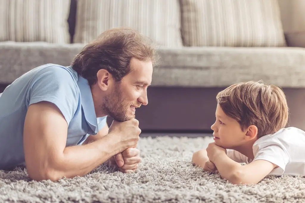 Man talking to his young son