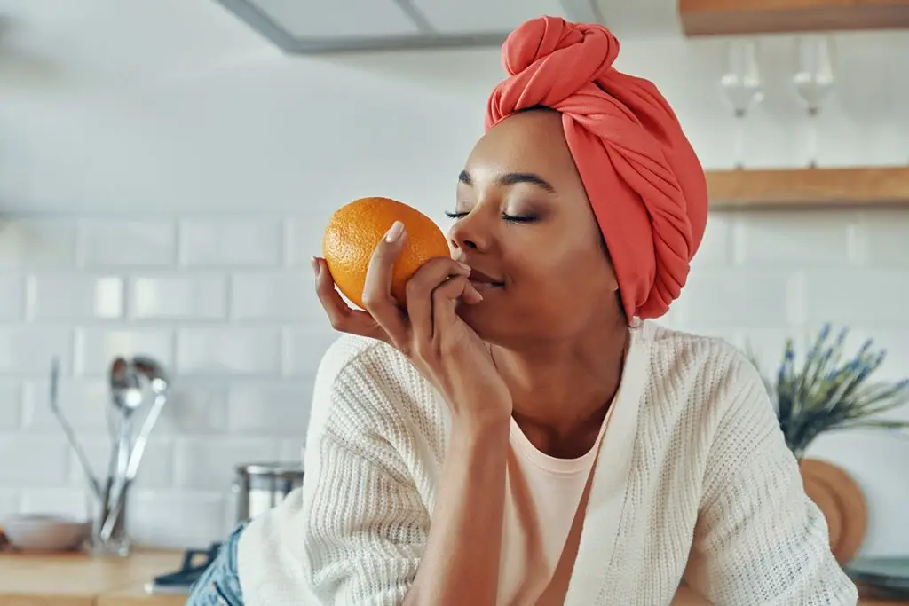 Woman smelling an orange