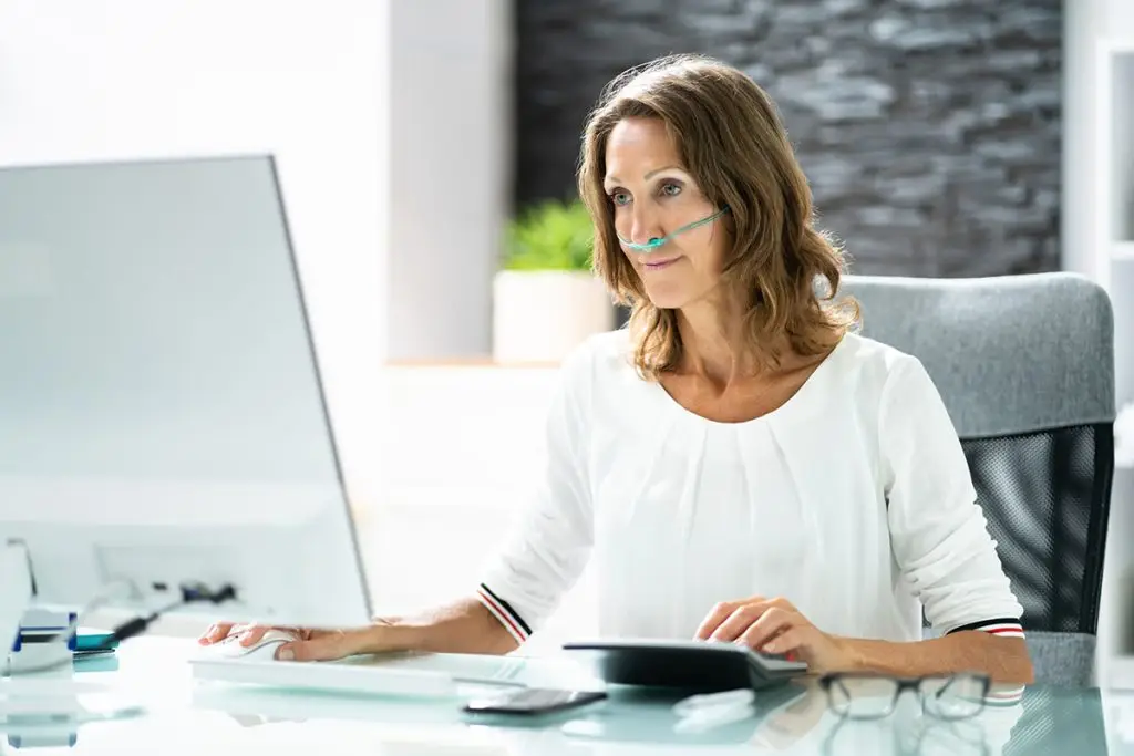 Woman Using Oxygen at the Office