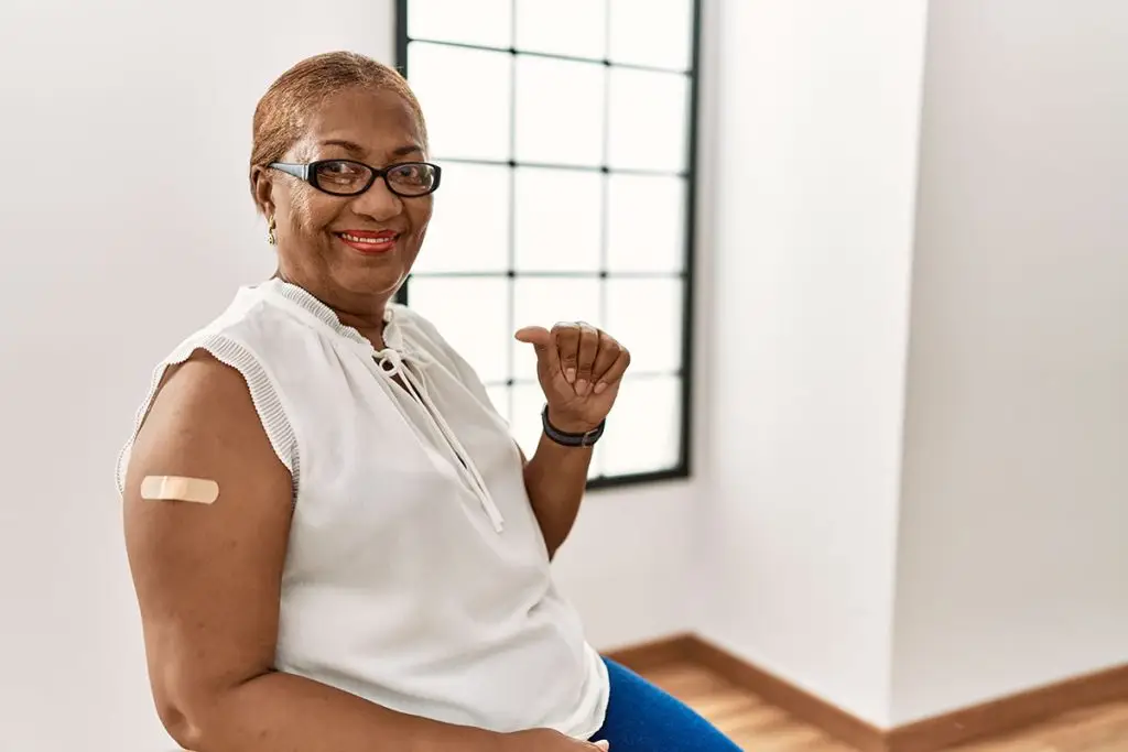 Woman with bandaid after a shingles vaccine