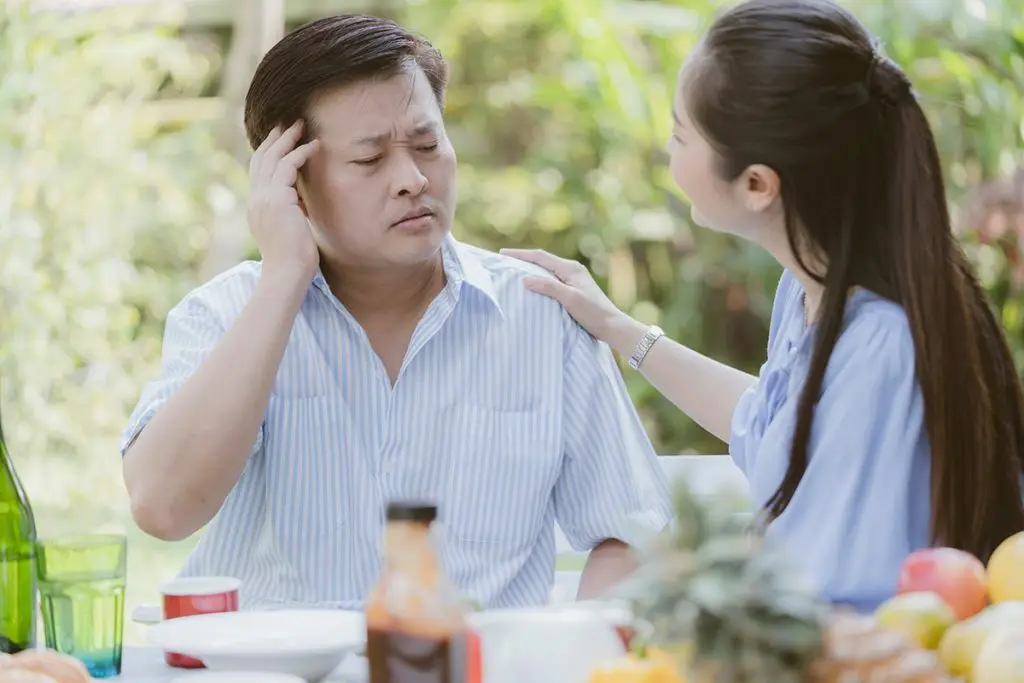 Man holding with head pain