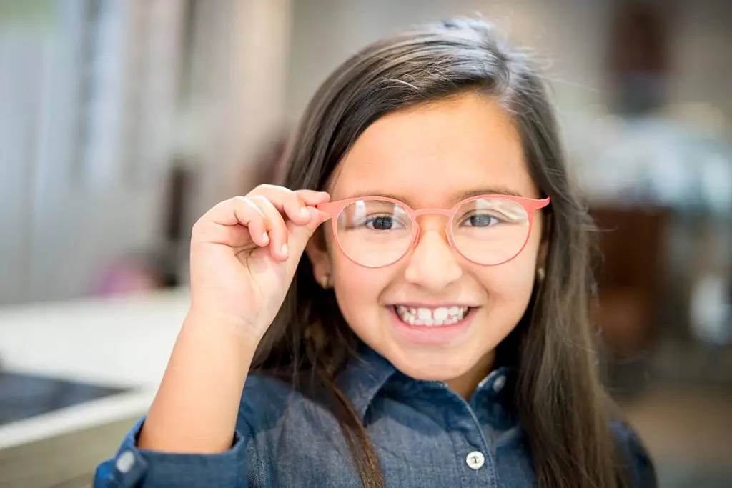 Girl trying glasses at the optician
