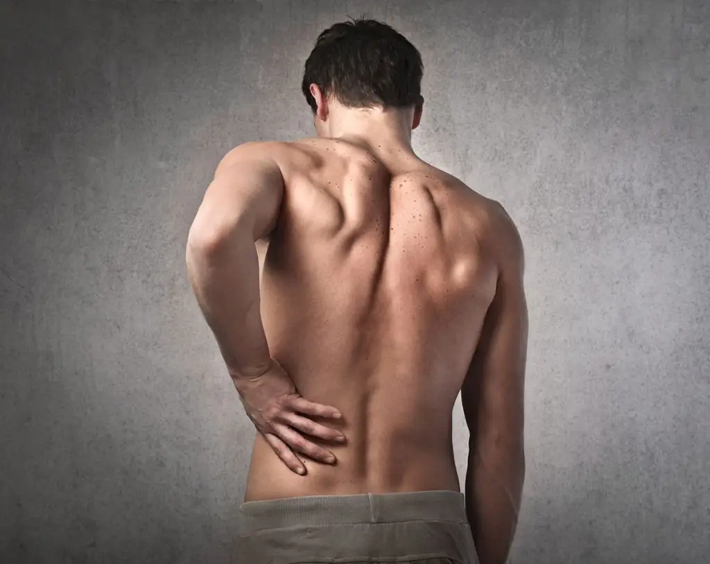 Man touching his lower back in pain