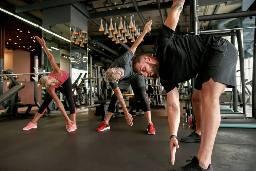 Three people stretching