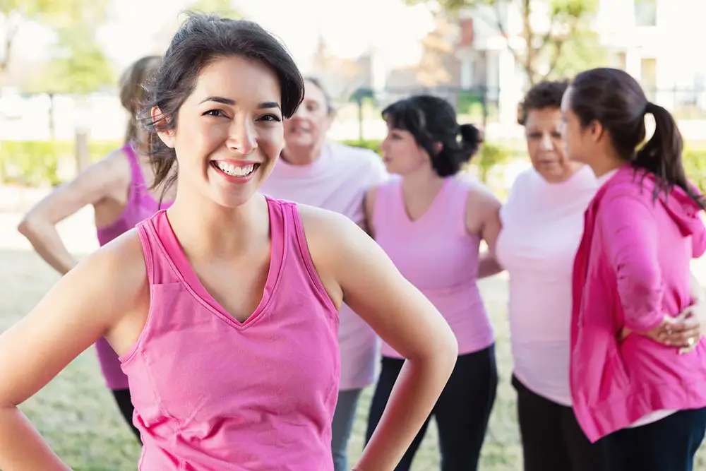 Healthy breast cancer survivor standing with friends outside