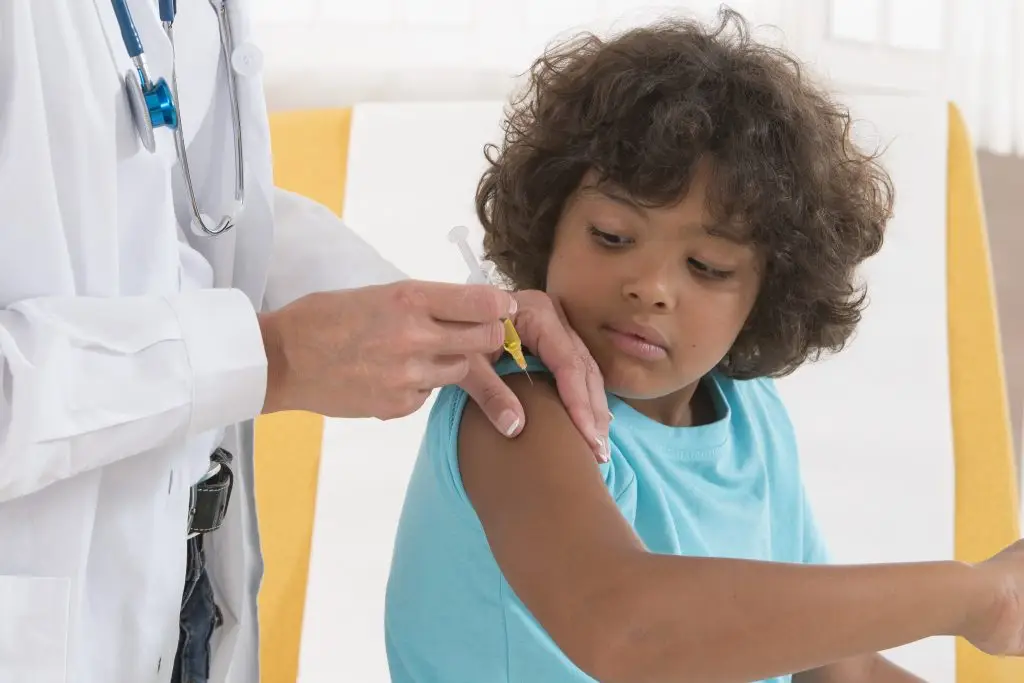 Little boy receives vaccine from physician