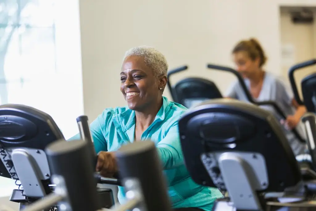 Senior African American woman at rehab center on exercise bike