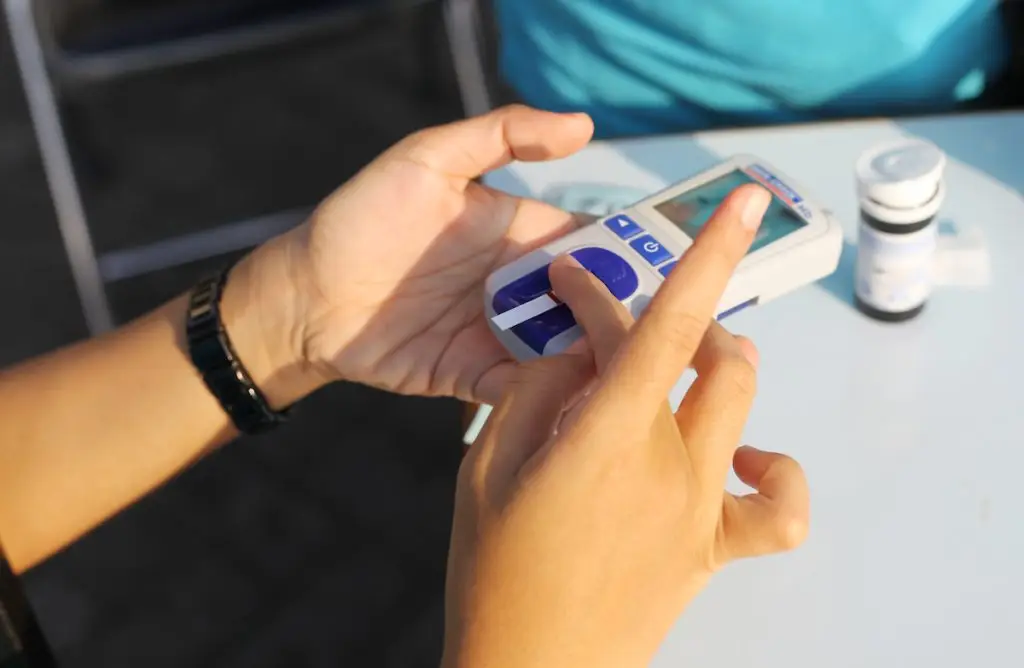 Woman measuring her A1C levels at home