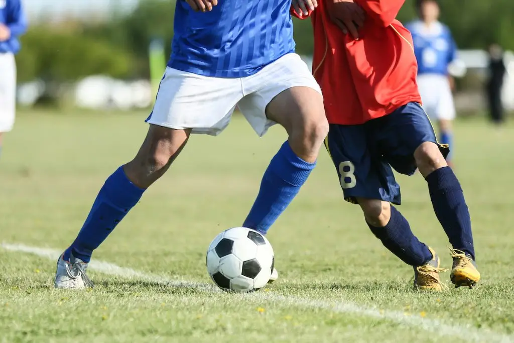 Teenagers playing soccer