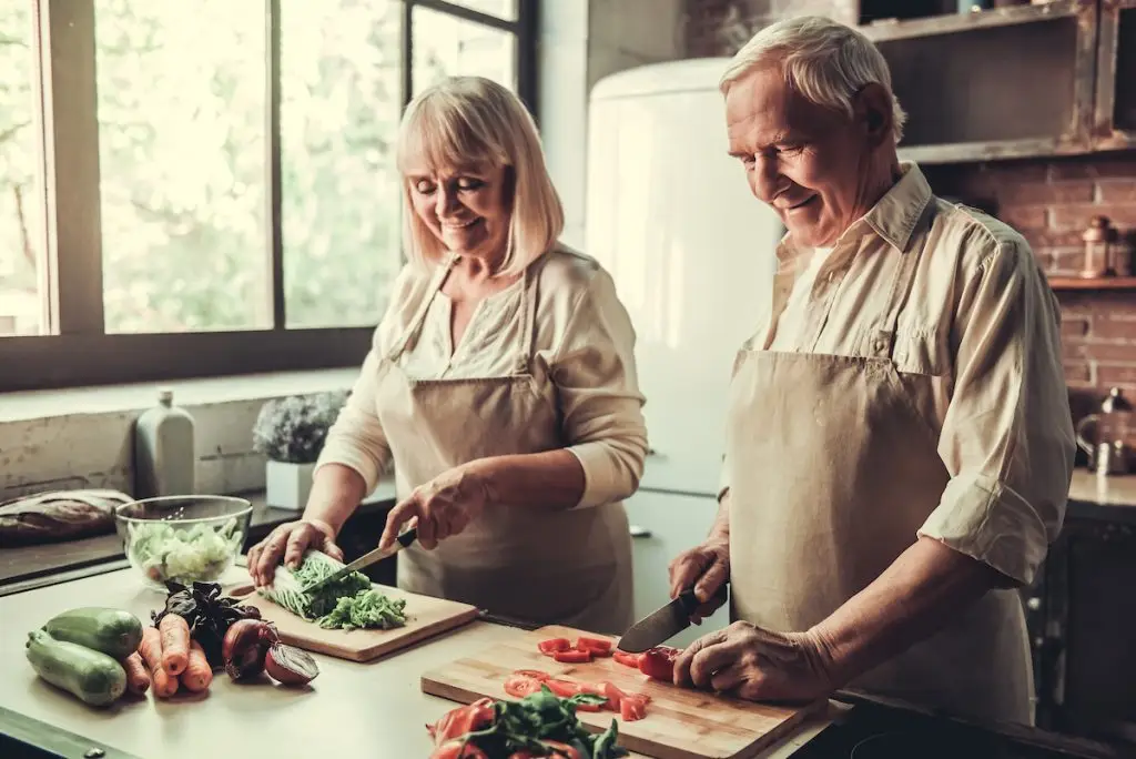Older couple cooking a healthy dinner together