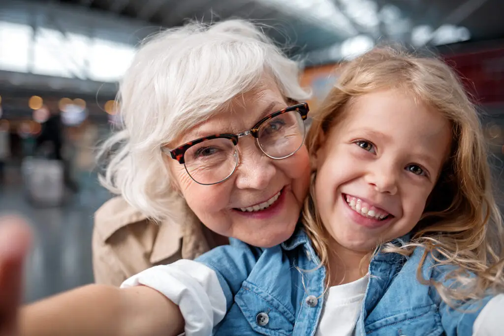 Grandmother at airport with granddaughter