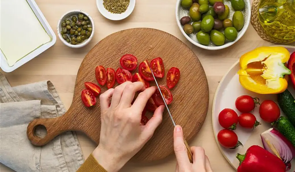 Woman cutting tomatoes dash diet