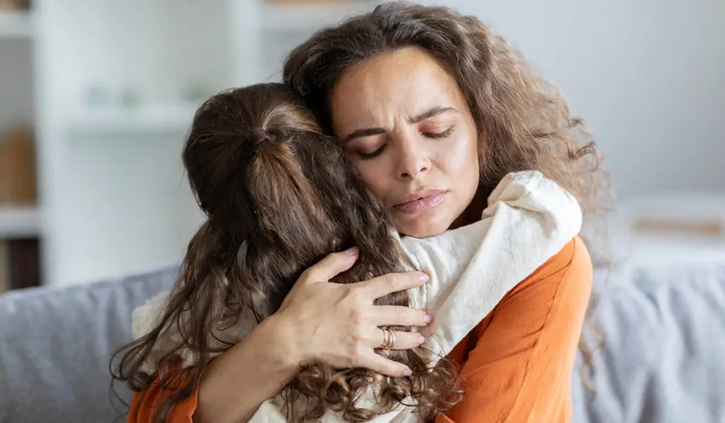 Mother hugging child