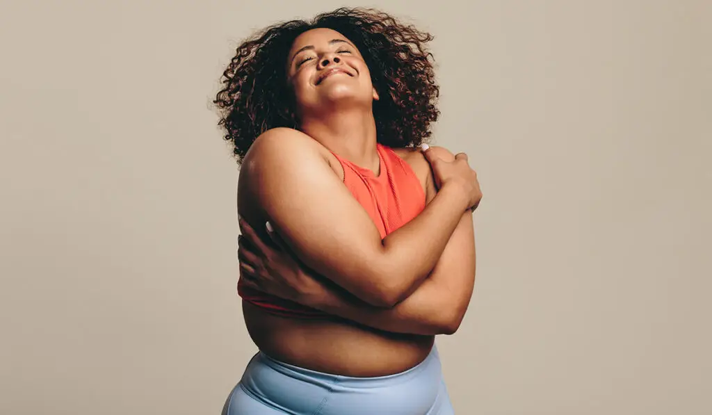 Woman hugging herself